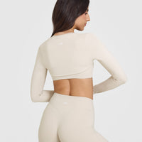 SoftMotion™ Long Sleeve Shrug with White Logo | Sand