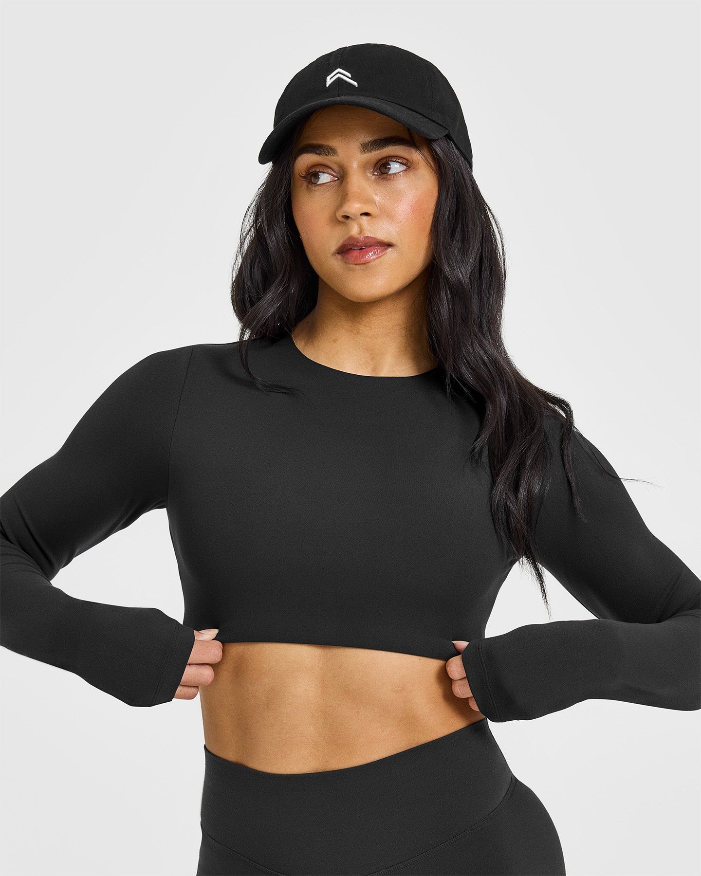 SoftMotion™ Long Sleeve Crop Top with White Logo | Soft Black