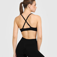 EnhanceLift™ Seamless Strappy Sports Bra with White Logo | Black