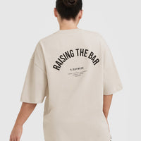 Raising The Bar Graphic Unisex T-Shirt | Sand