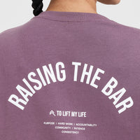 Raising The Bar Graphic Unisex T-Shirt | Vintage Purple