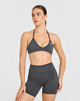 EnhanceLift™ Seamless Minimal Halter Neck Bralette with White Logo | Coal