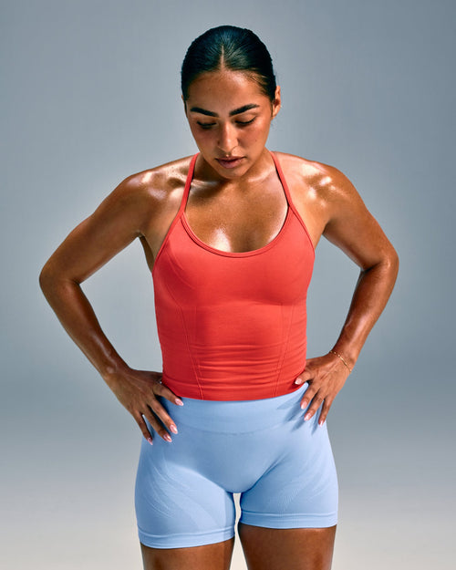 EnhanceLift™ Seamless Strappy Racer Tank Top with Built in Bra Shelf with Gray Logo | Dark Charged Coral