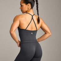 EnhanceLift™ Seamless Strappy Racer Vest with Built in Bra Shelf with Grey Logo | Coal