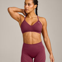 EnhanceLift™ Seamless Strappy Sports Bra with Grey Logo | Burnt Maroon