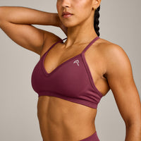 EnhanceLift™ Seamless Strappy Sports Bra with Grey Logo | Burnt Maroon
