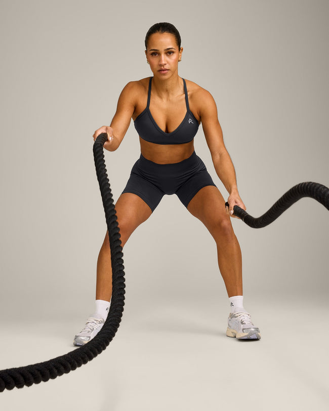 EnhanceLift™ Seamless Strappy Sports Bra with Grey Logo | Coal