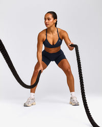 EnhanceLift™ Seamless Strappy Sports Bra with Grey Logo | True Blue