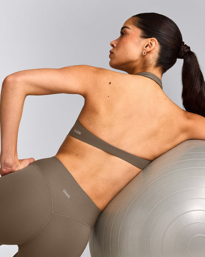 SoftMotion™ Minimal Halter Neck Bralette with Grey Logo | Moss Brown