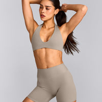 SoftMotion™ Minimal Halter Neck Bralette with White Logo | Warm Sand