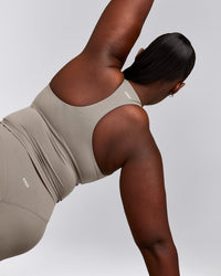 SoftMotion™ Racer Back Mid Tank Top with Built in Bra Shelf with White Logo | Warm Sand
