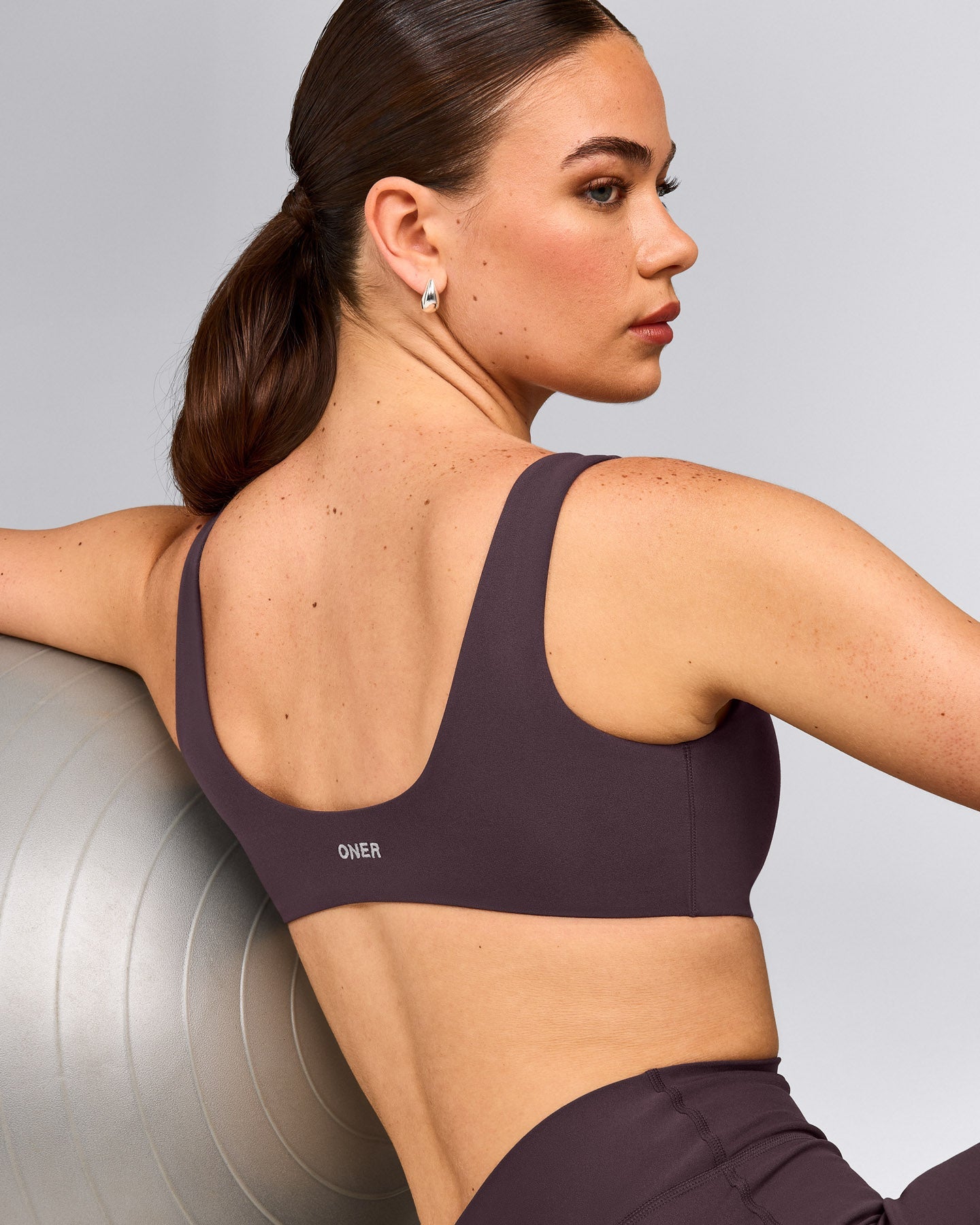 SoftMotion™ Scoop Back Bralette with Gray Logo | Dark Umber Brown