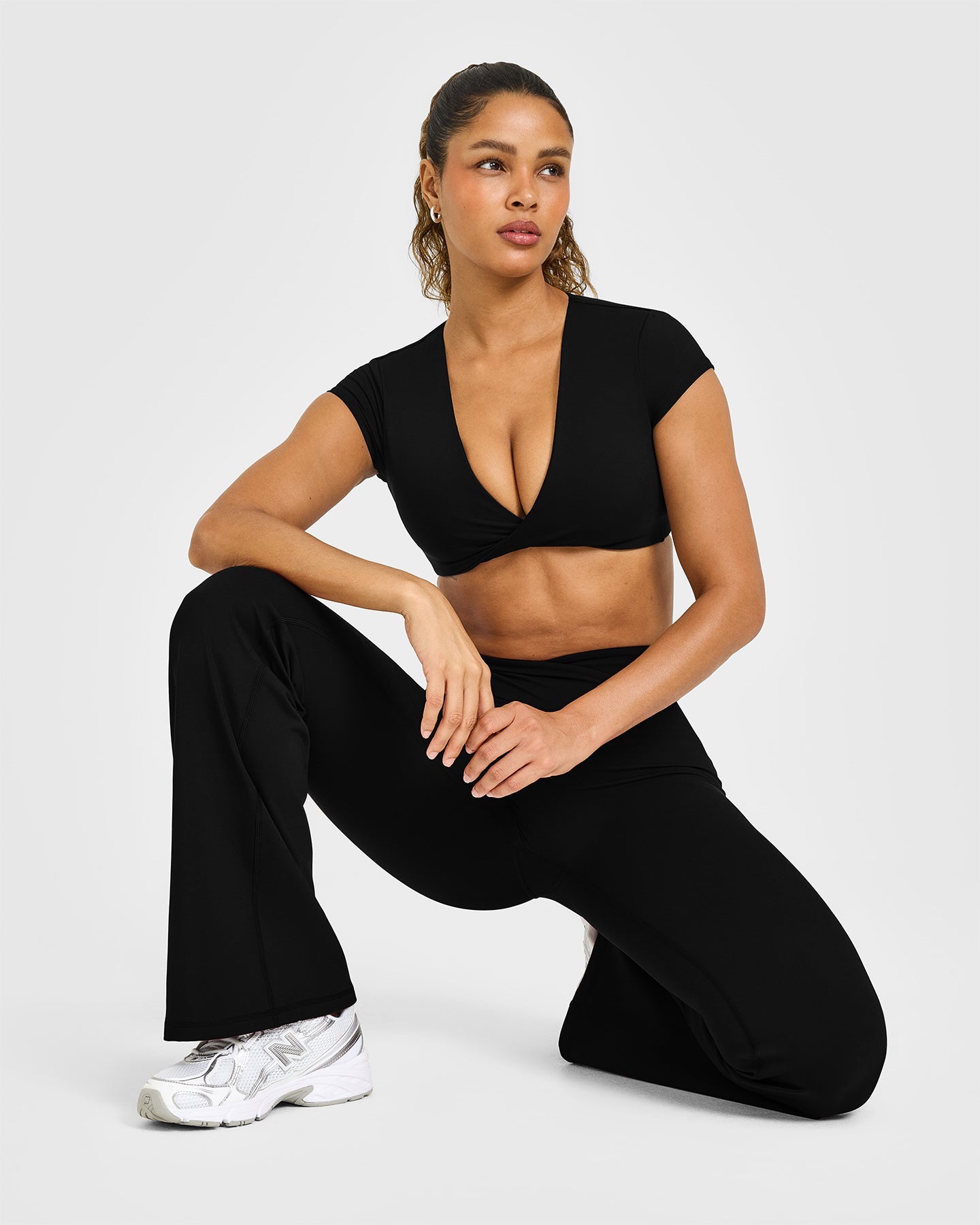 Unified Twist Front Short Sleeve Crop Top White Logo | Black