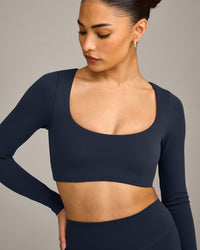 SoftMotion™ Scoop Neck Long Sleeve Crop Top with Built in Bra Shelf with Grey Logo | True Blue