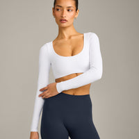 SoftMotion™ Scoop Neck Long Sleeve Crop Top with Built in Bra Shelf with Grey Logo | White