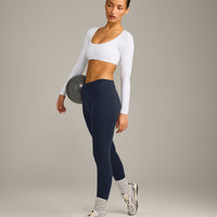 SoftMotion™ Scoop Neck Long Sleeve Crop Top with Built in Bra Shelf with Grey Logo | White