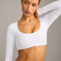 SoftMotion™ Scoop Neck Long Sleeve Crop Top with Built in Bra Shelf with Grey Logo | White
