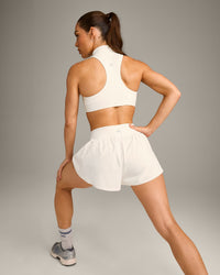 EasyLift™ Zip High Neck Sports Bra with Grey Logo | Marshmallow White