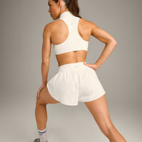 EasyLift™ Zip High Neck Sports Bra with Grey Logo | Marshmallow White