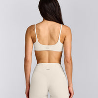 SoftMotion™ Strappy Sports Bra with Grey Logo | Marshmallow White
