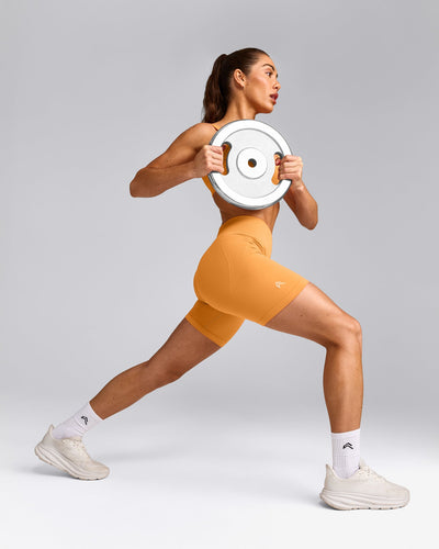 EffortlessLift™ Seamless Mid Rise Shorts with Grey Logo | Powdered Orange