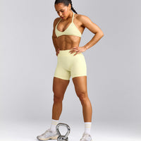 EnhanceLift™ Seamless Minimal Halter Neck Bralette with Grey Logo | Pastel Yellow
