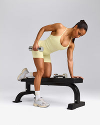 EnhanceLift™ Seamless Strappy Racer Vest with Built in Bra Shelf with Grey Logo | Pastel Yellow