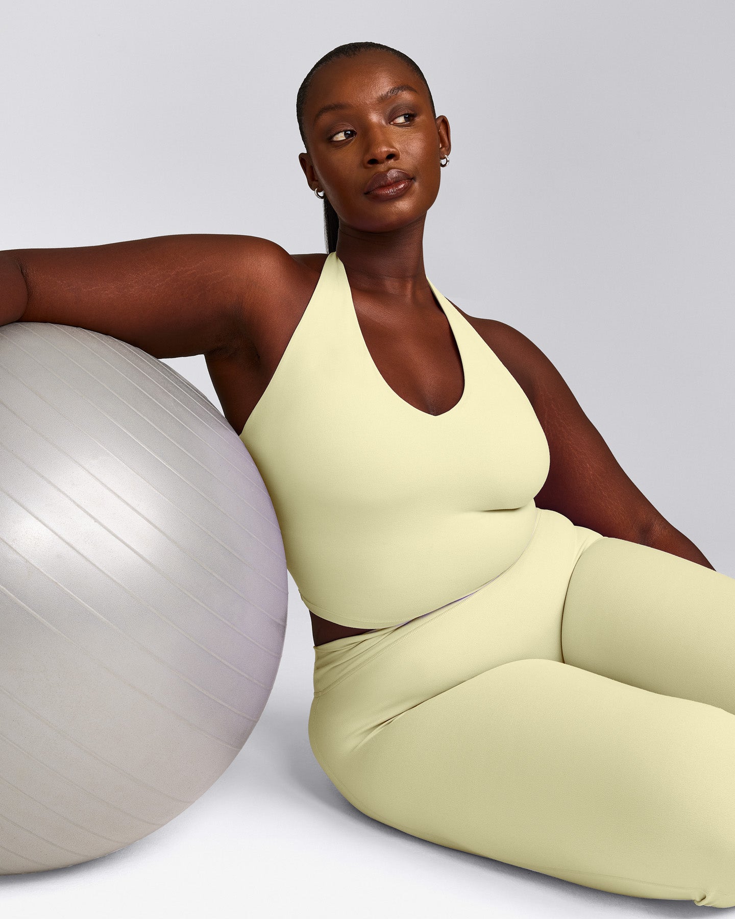 SoftMotion™ Halter Neck Mid Vest with Built in Bra Shelf with Grey Logo | Pastel Yellow