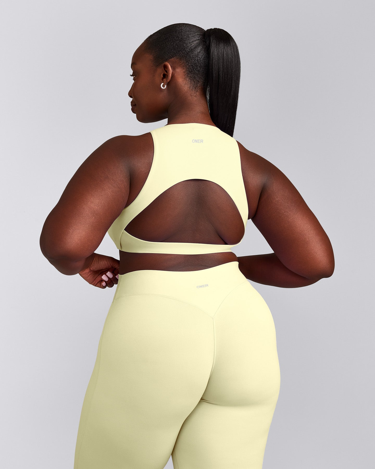 SoftMotion™ High Neck Sports Bra with Grey Logo | Pastel Yellow