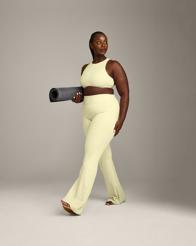 SoftMotion™ High Neck Sports Bra with Grey Logo | Pastel Yellow