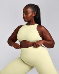 SoftMotion™ High Neck Sports Bra with Grey Logo | Pastel Yellow