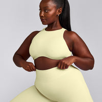SoftMotion™ High Neck Sports Bra with Grey Logo | Pastel Yellow