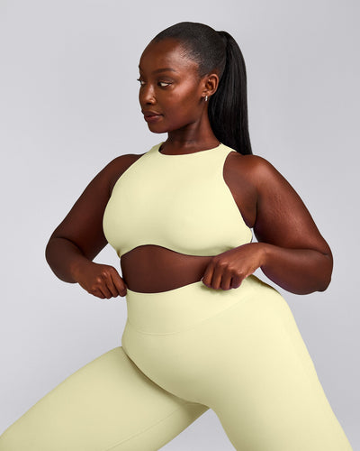 SoftMotion™ High Neck Sports Bra with Grey Logo | Pastel Yellow