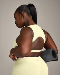 SoftMotion™ High Neck Sports Bra with Grey Logo | Pastel Yellow