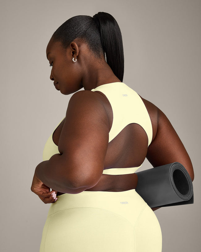 SoftMotion™ High Neck Sports Bra with Grey Logo | Pastel Yellow