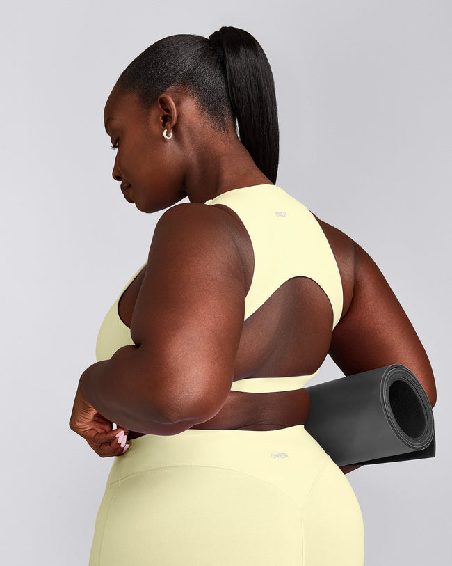 SoftMotion™ High Neck Sports Bra with Grey Logo | Pastel Yellow