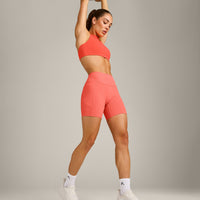 EasyLift™ High Neck Sports Bra with Grey Logo | Hyper Orange