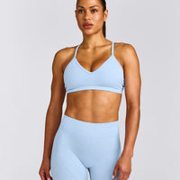EnhanceLift™ Seamless Strappy Sports Bra with Gray Logo | Powdered Blue