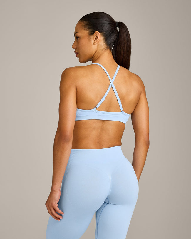 EnhanceLift™ Seamless Strappy Sports Bra with Grey Logo | Powdered Blue