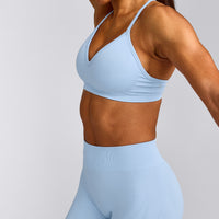 EnhanceLift™ Seamless Strappy Sports Bra with Gray Logo | Powdered Blue