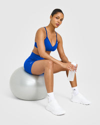 EnhanceLift™ Seamless Strappy Sports Bra with White Logo | Cobalt Blue